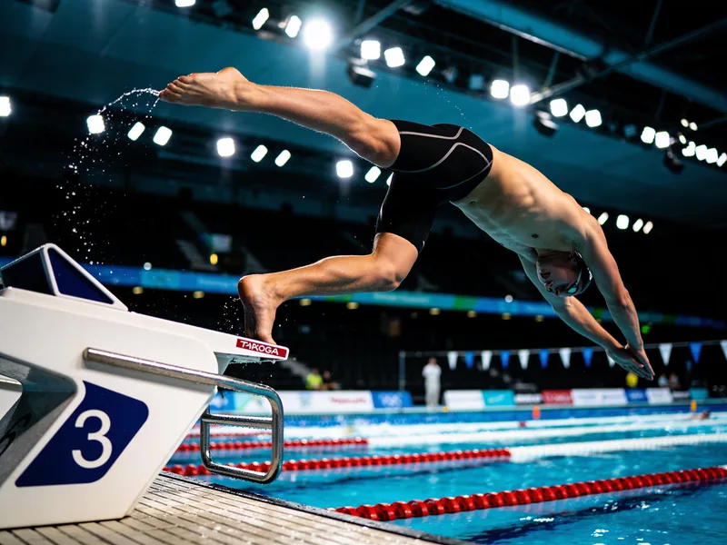 A guest transformed into a competitive swimmer in a pool lane